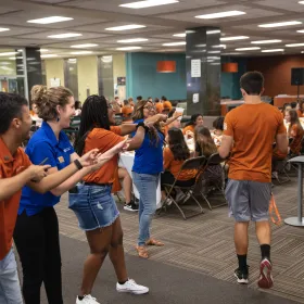 Volunteers help students find a place to sit at Gone to Undergraduate Studies