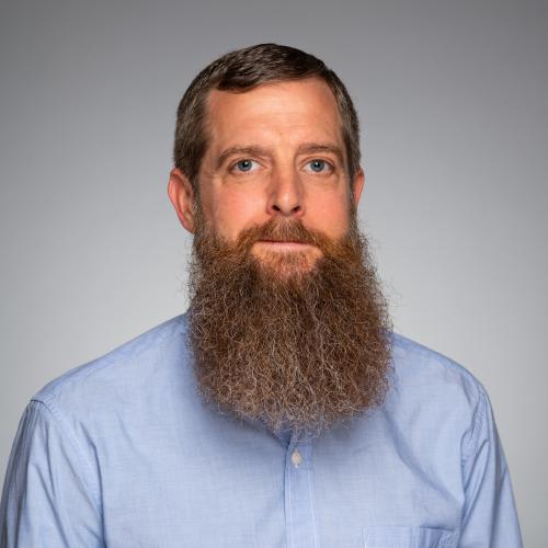 Picture of Jay Whitehead on a gray background.