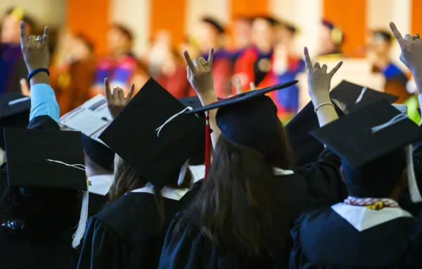 Students in cap and gowns at graduation
