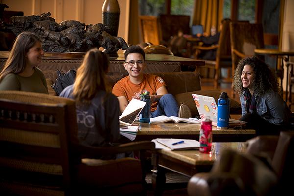 Four students sitting and talking