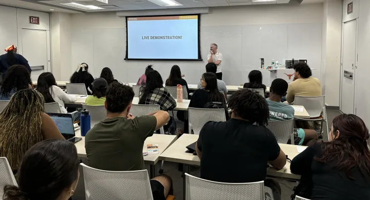 Students in a classroom watching a presentation for the ULN Symposium