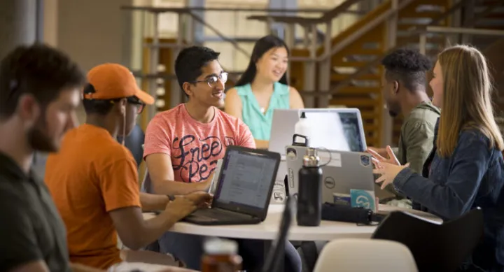 Students sitting in lounge working on computers