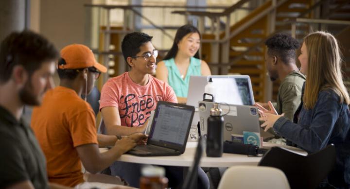 Students sitting in lounge working on computers