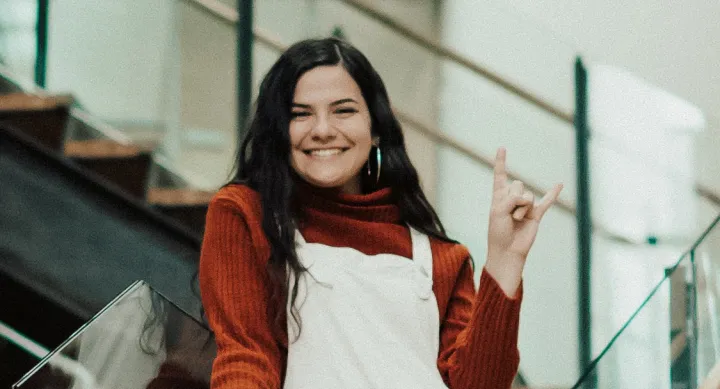 Victoria Hart Victoria Hart smiles and makes a hook 'em hand sign.