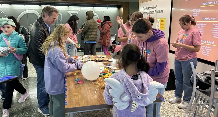 K-8 grade students checking out a STEM Girl Day demonstration