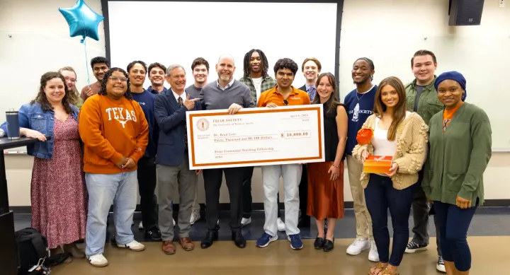 Brad Love in a group of students holding check
