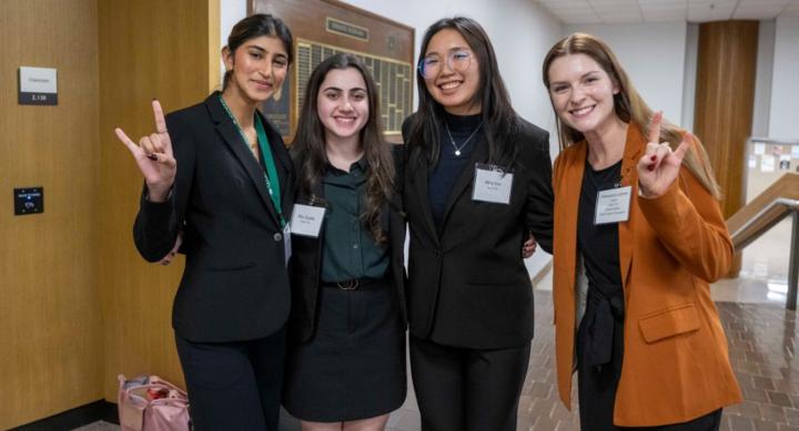 Minji Kim at conference, with group of students
